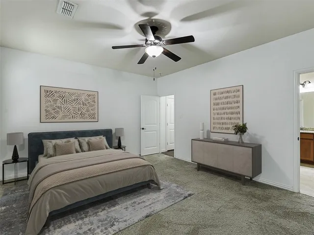a bedroom with a large bed and a chandelier