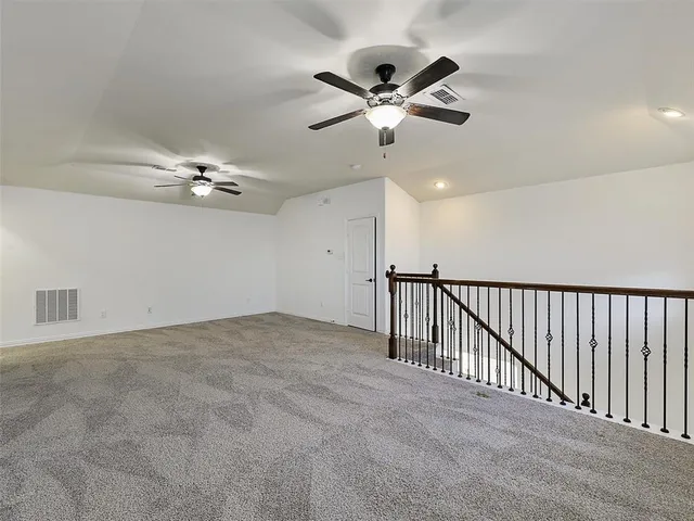 a view of a livingroom and a chandelier fan