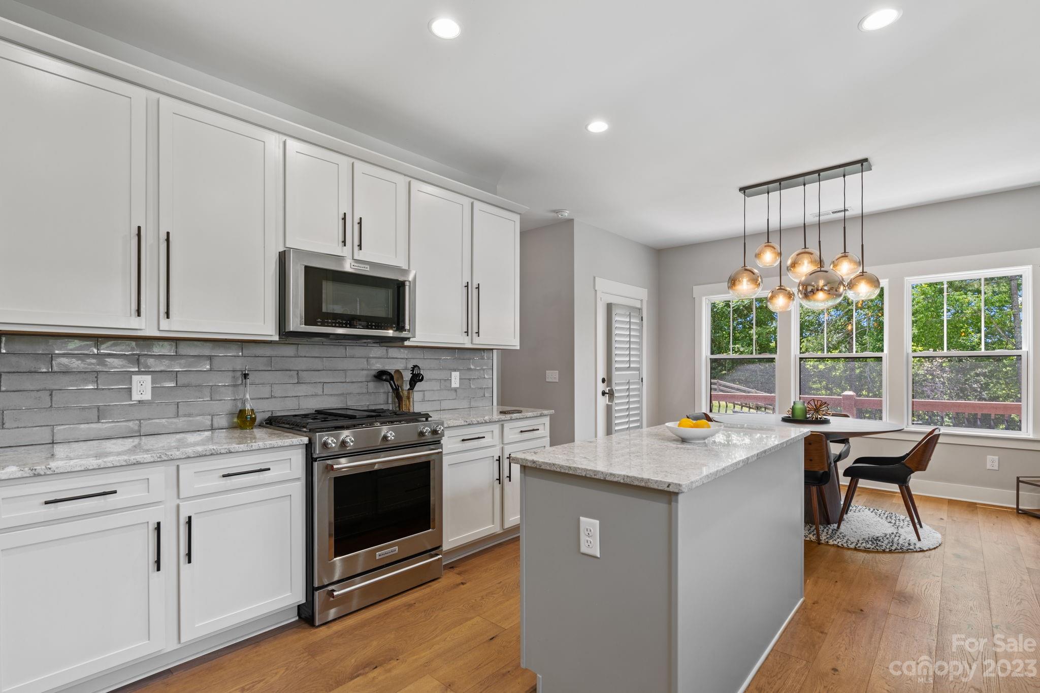 44 Reta Road Fairview, NC 28730 - Photo 16 of 36 a kitchen with a stove a sink and a microwave