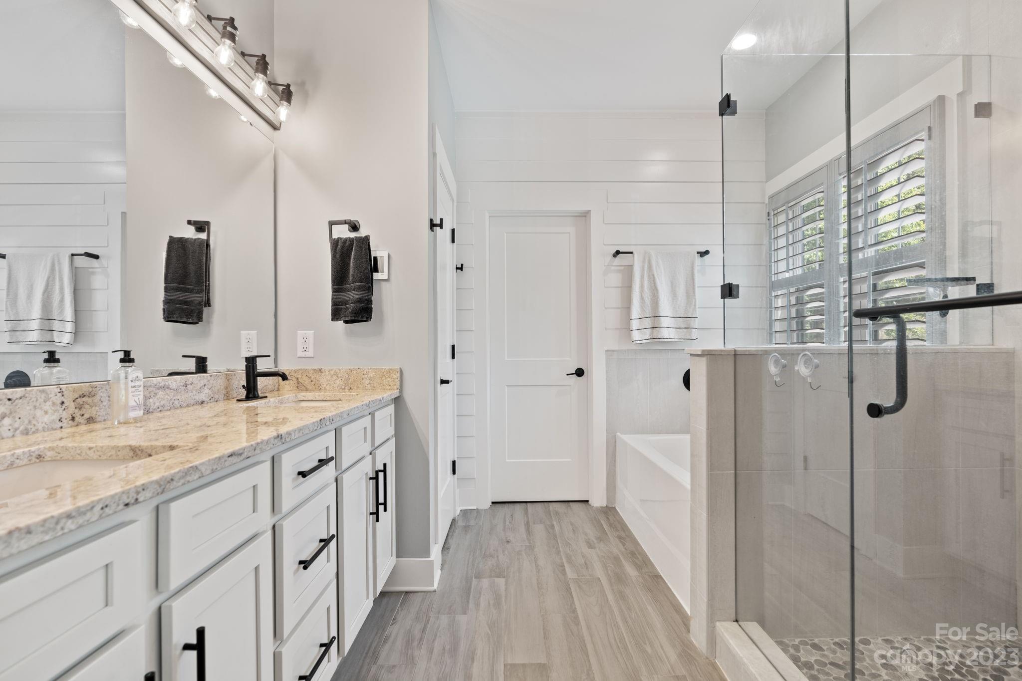 44 Reta Road Fairview, NC 28730 - Photo 20 of 36 a spacious bathroom with double vanity and mirrors
