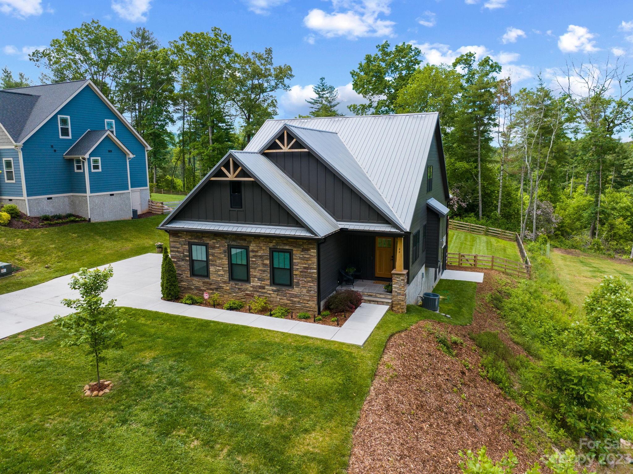 44 Reta Road Fairview, NC 28730 - Photo 2 of 36 a view of house with garden and tall trees