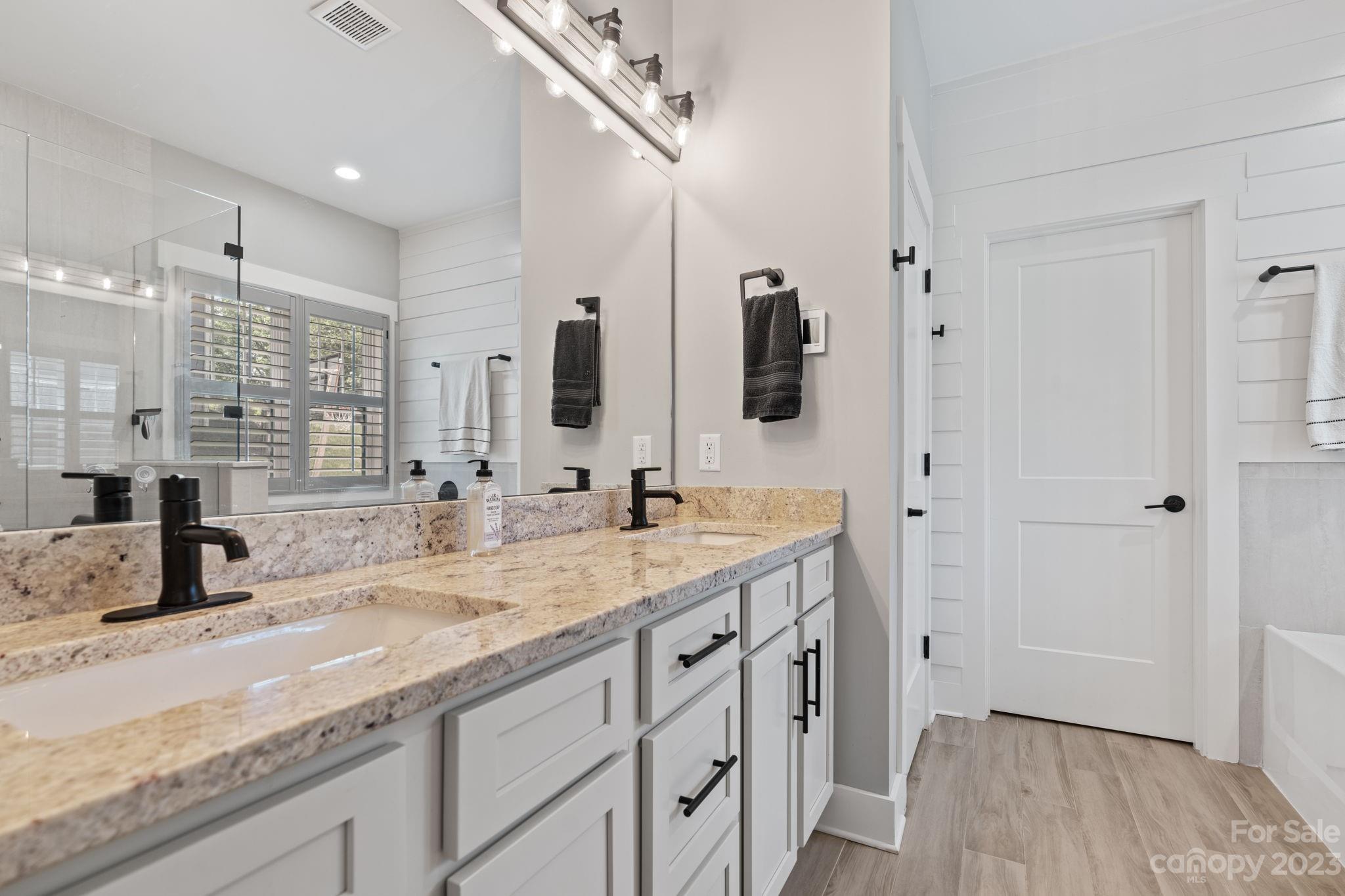 44 Reta Road Fairview, NC 28730 - Photo 21 of 36 a bathroom with double vanity sink and mirror