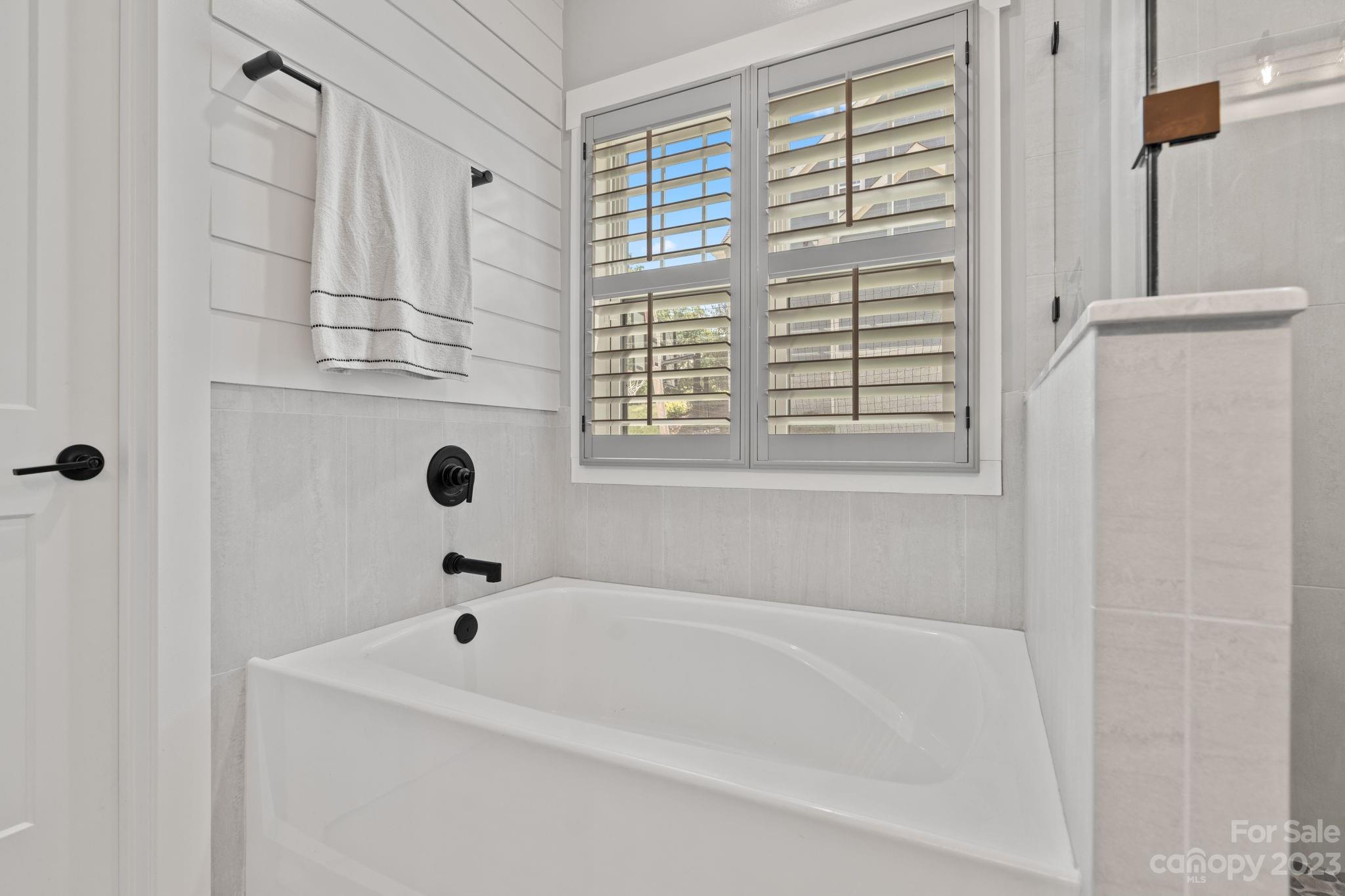 44 Reta Road Fairview, NC 28730 - Photo 22 of 36 a white bath tub sitting next to a window
