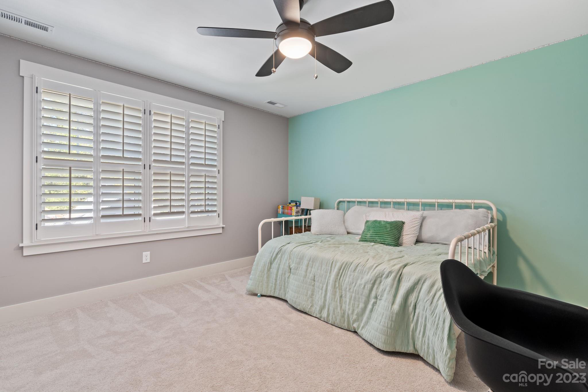 44 Reta Road Fairview, NC 28730 - Photo 26 of 36 a bedroom with a bed and a window