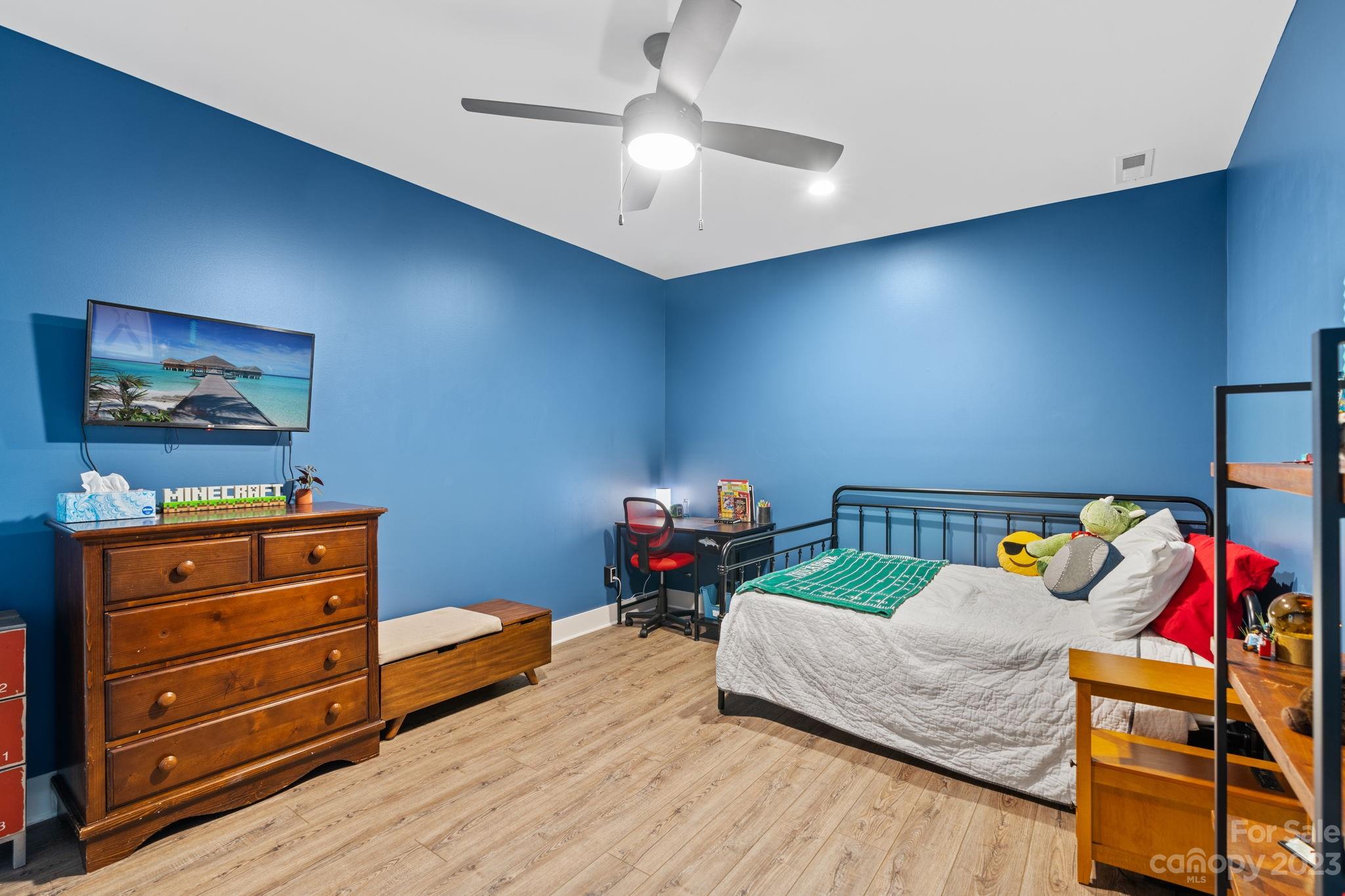 44 Reta Road Fairview, NC 28730 - Photo 32 of 36 a bedroom with furniture and a wooden floor