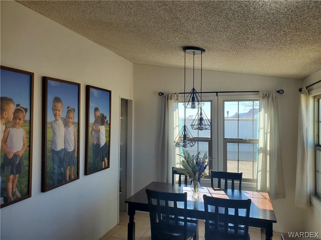 2277 Egar Road Golden Valley, AZ 86413 - Photo 11 of 28 a view of a dining room with furniture window and outside view
