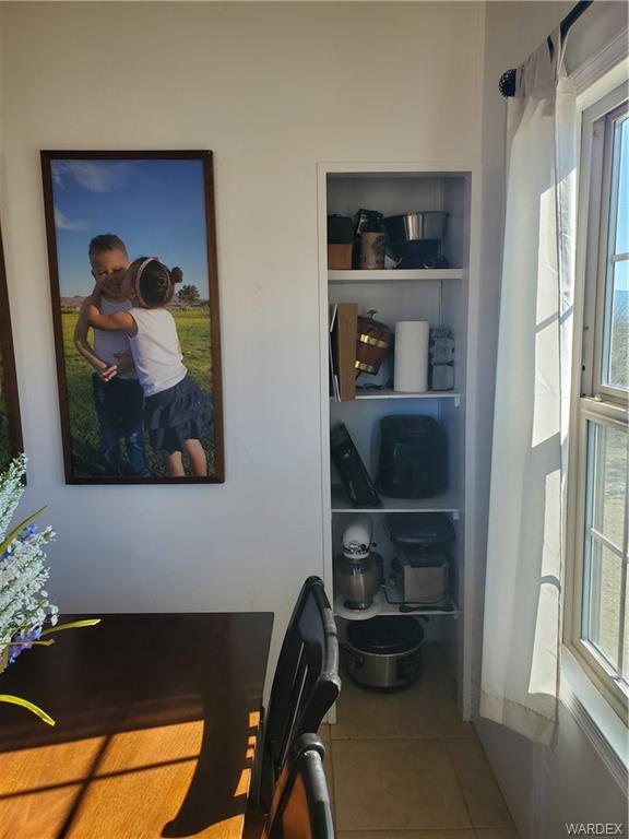 2277 Egar Road Golden Valley, AZ 86413 - Photo 12 of 28 a living room with a painting on the wall and a potted plant