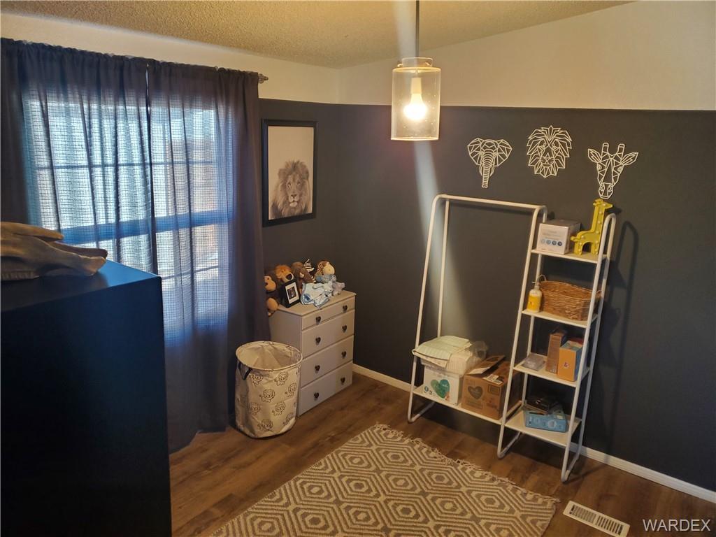 2277 Egar Road Golden Valley, AZ 86413 - Photo 24 of 28 a room with furniture a rug and a window