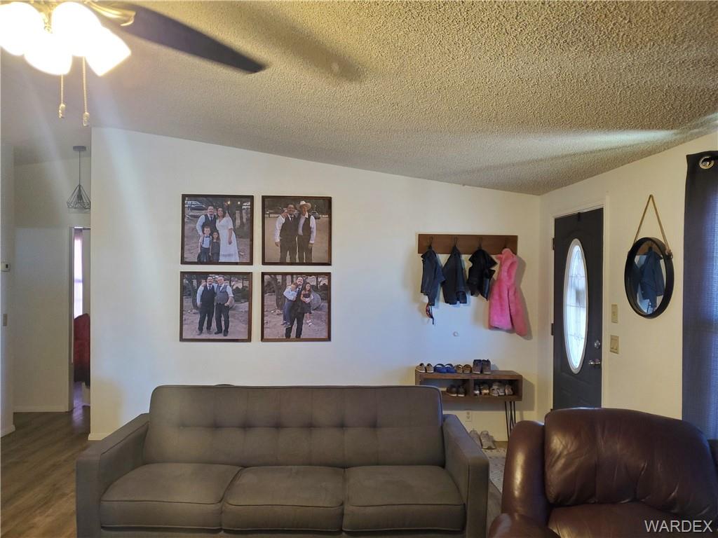 2277 Egar Road Golden Valley, AZ 86413 - Photo 4 of 28 a living room with furniture and a window