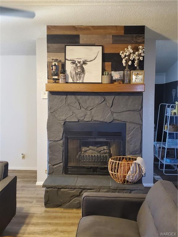 2277 Egar Road Golden Valley, AZ 86413 - Photo 7 of 28 a living room with furniture and a fireplace
