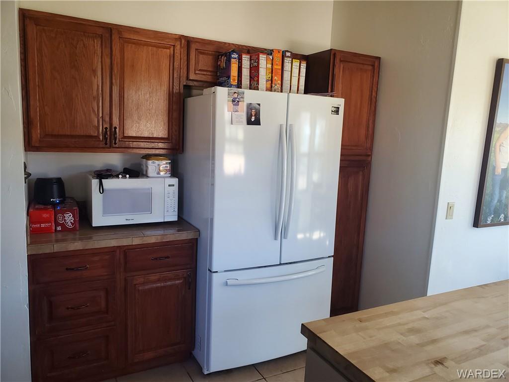 2277 Egar Road Golden Valley, AZ 86413 - Photo 10 of 28 a white refrigerator freezer sitting in a kitchen