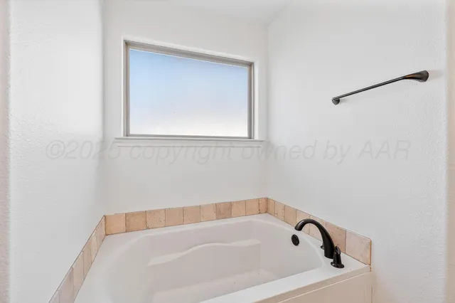 a white bath tub sitting in a bathroom