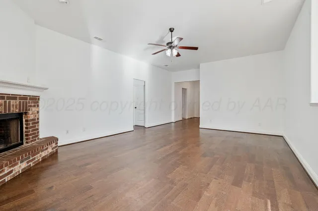a view of an empty room with a fireplace