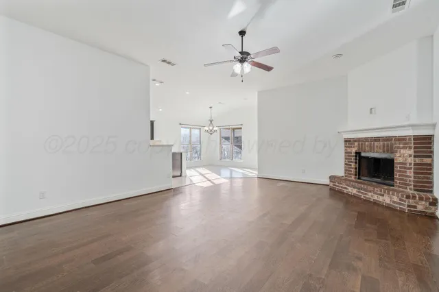 wooden floor in an empty room with a fireplace