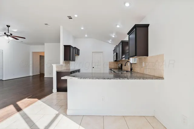 a view of living room with granite countertop furniture and a fireplace