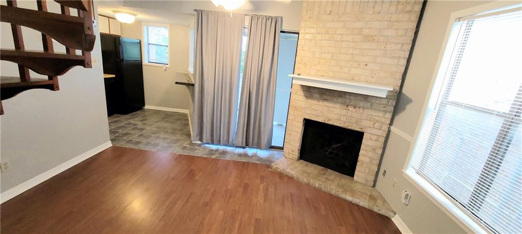 2500 Burleson Road, Unit 611 Austin, TX 78741 - Photo 2 of 22 a view of a livingroom with wooden floor and a fireplace
