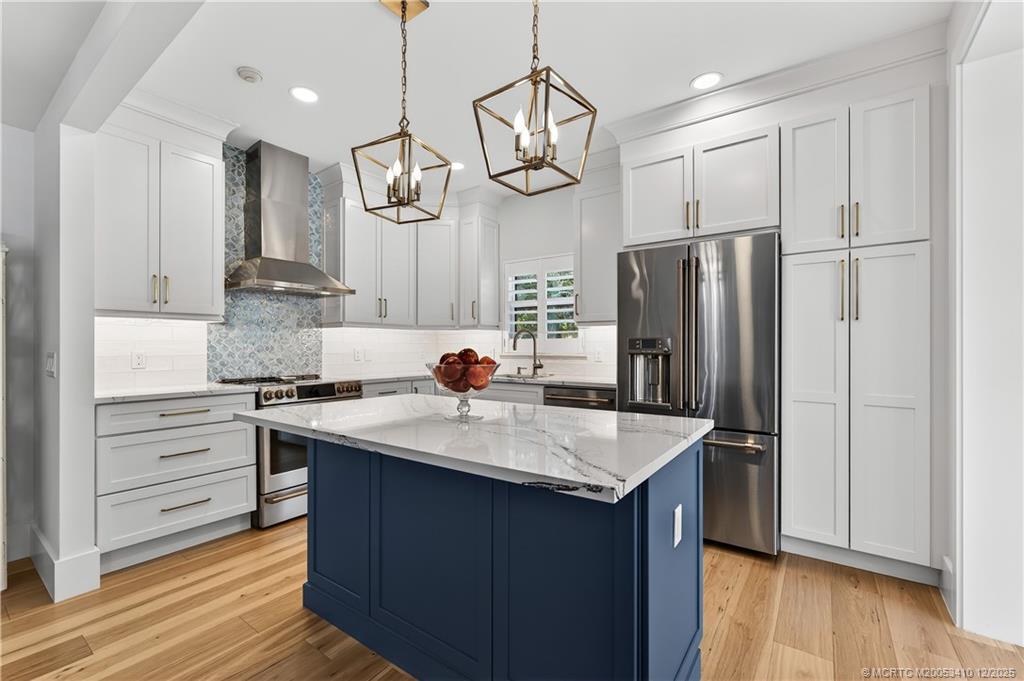 12445 Harbour Ridge Boulevard, Unit 38 Palm City, FL 34990 - Photo 15 of 46 a kitchen with stainless steel appliances granite countertop a sink refrigerator and cabinets