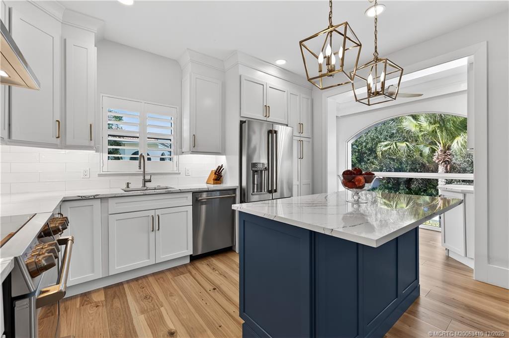 12445 Harbour Ridge Boulevard, Unit 38 Palm City, FL 34990 - Photo 16 of 46 a kitchen with stainless steel appliances granite countertop a sink stove and refrigerator