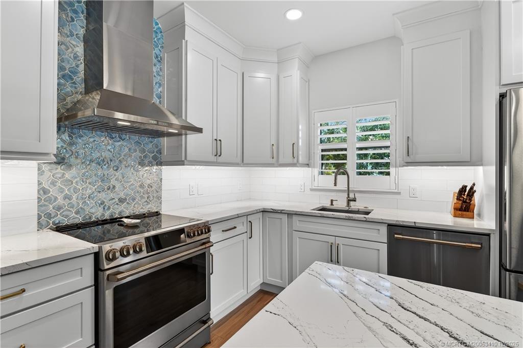 12445 Harbour Ridge Boulevard, Unit 38 Palm City, FL 34990 - Photo 17 of 46 a kitchen with a sink stove and cabinets