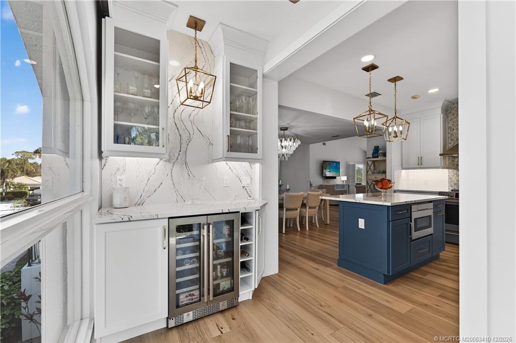 12445 Harbour Ridge Boulevard, Unit 38 Palm City, FL 34990 - Photo 19 of 46 a kitchen with stainless steel appliances granite countertop a stove and a wooden floors
