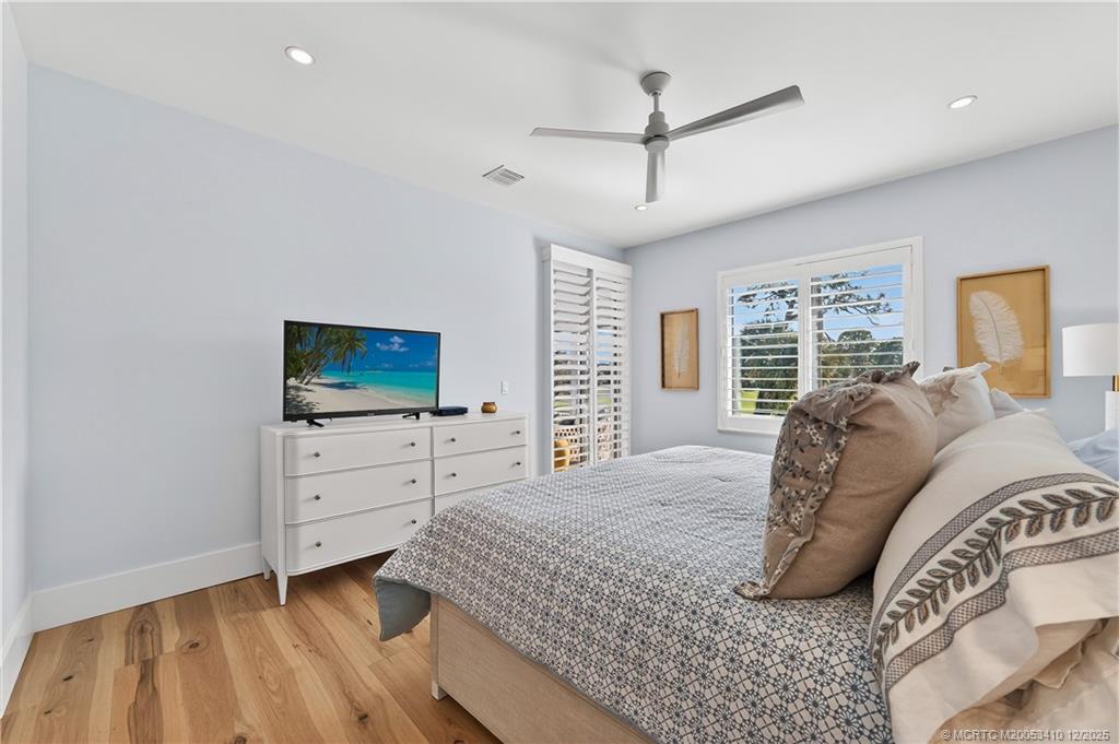 12445 Harbour Ridge Boulevard, Unit 38 Palm City, FL 34990 - Photo 23 of 46 a spacious bedroom with a bed and a flat screen tv