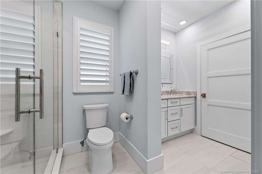 12445 Harbour Ridge Boulevard, Unit 38 Palm City, FL 34990 - Photo 25 of 46 a bathroom with a toilet a sink and shower