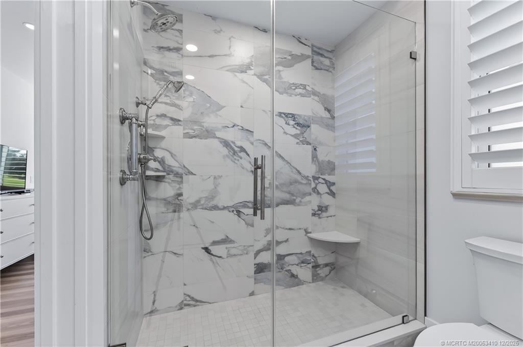 12445 Harbour Ridge Boulevard, Unit 38 Palm City, FL 34990 - Photo 27 of 46 a bathroom with a toilet and shower