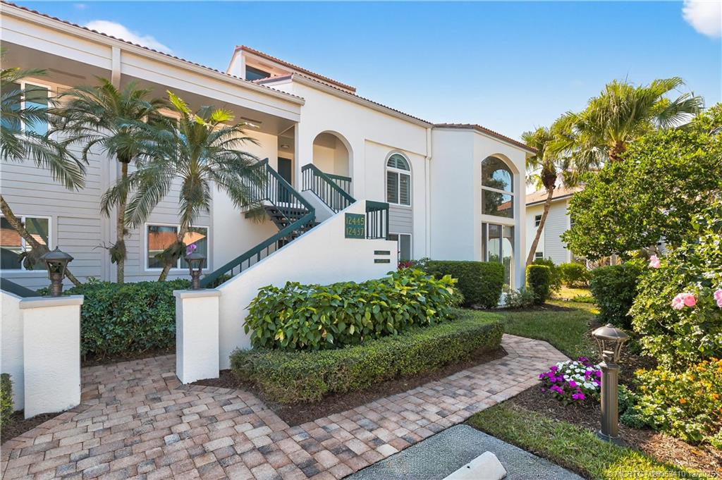 12445 Harbour Ridge Boulevard, Unit 38 Palm City, FL 34990 - Photo 3 of 46 a front view of a house with a yard