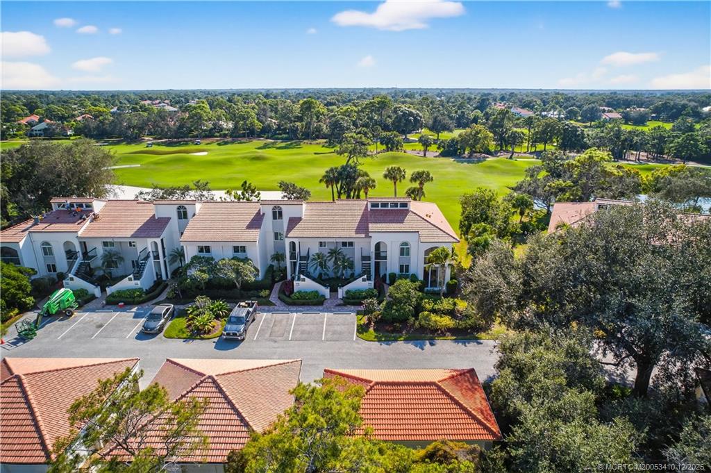 12445 Harbour Ridge Boulevard, Unit 38 Palm City, FL 34990 - Photo 35 of 46 an aerial view of residential houses with swimming pool and outdoor space