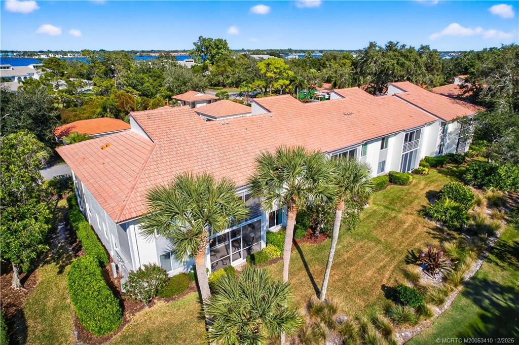 12445 Harbour Ridge Boulevard, Unit 38 Palm City, FL 34990 - Photo 37 of 46 an aerial view of a house with a yard and lake view