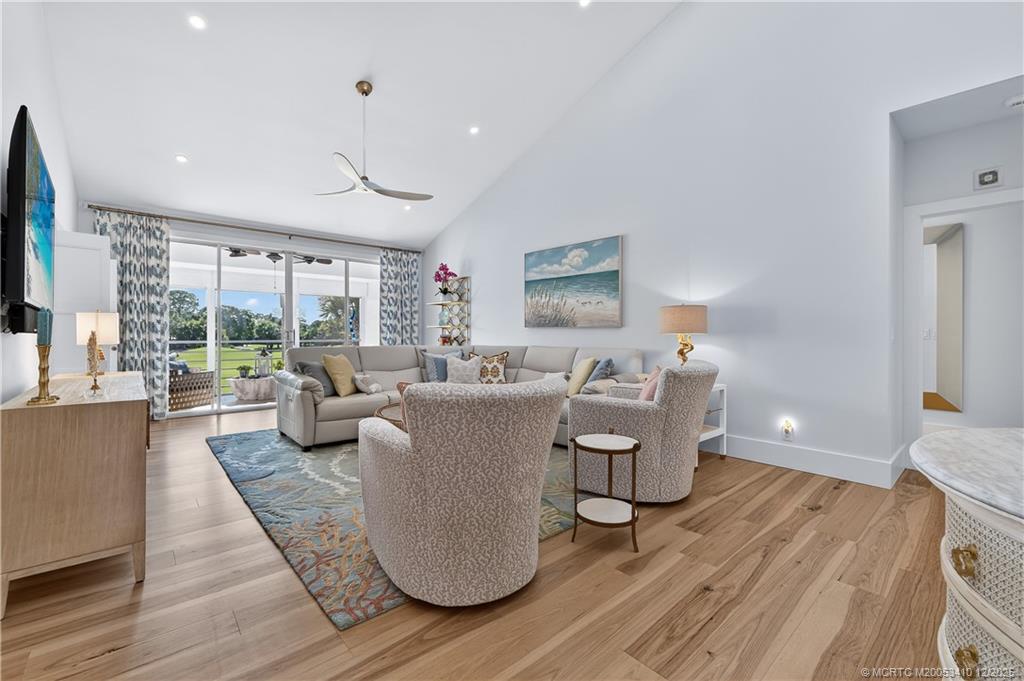 12445 Harbour Ridge Boulevard, Unit 38 Palm City, FL 34990 - Photo 5 of 46 a living room with furniture a large window and wooden floor