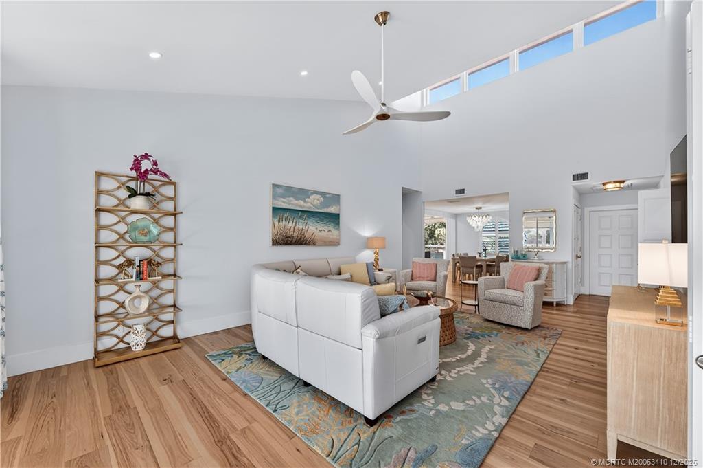 12445 Harbour Ridge Boulevard, Unit 38 Palm City, FL 34990 - Photo 9 of 46 a living room with furniture and a wooden floor