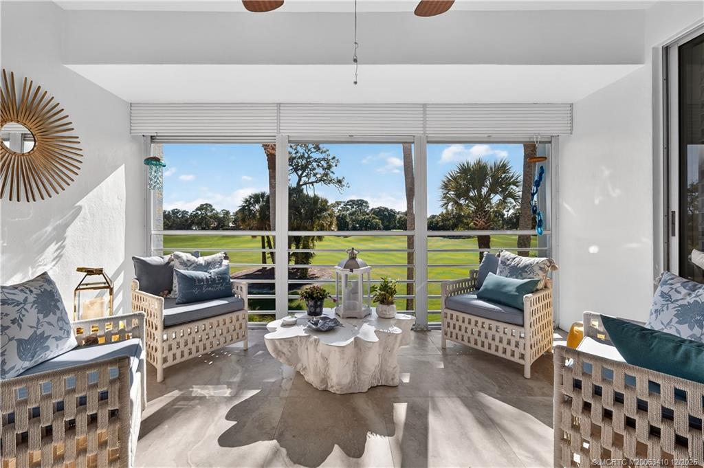 12445 Harbour Ridge Boulevard, Unit 38 Palm City, FL 34990 - Photo 10 of 46 a living room with furniture and a floor to ceiling window