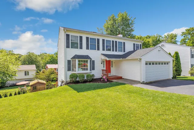 a view of a house with a yard and sitting area