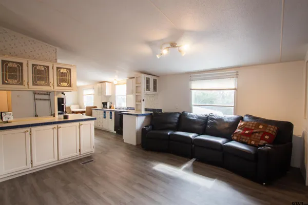 a living room with furniture and kitchen view