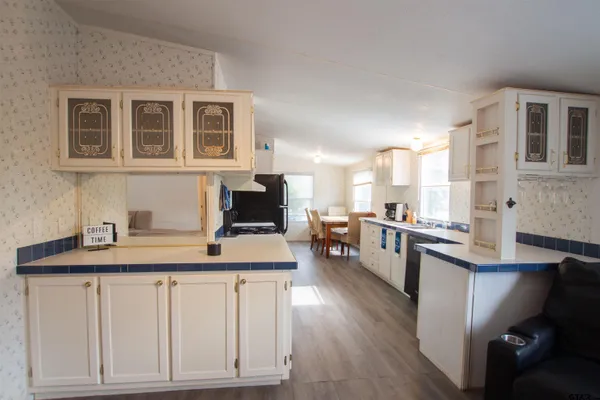 a kitchen with a sink cabinets and wooden floor