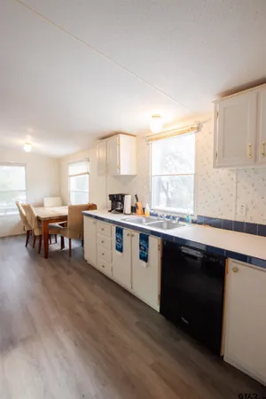 a large white kitchen with a large window