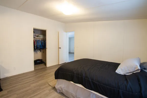 a bedroom with a bed and a lamp on the table