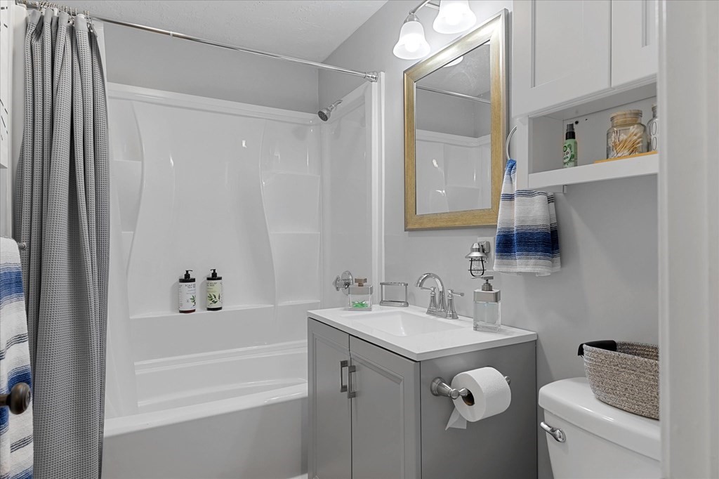 46 Gibbs Street, Unit 1D Worcester, MA 01607 - Photo 14 of 17 a bathroom with a granite countertop sink a toilet and shower