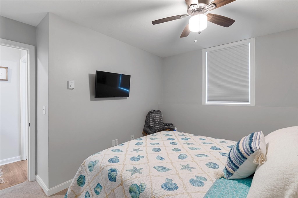 46 Gibbs Street, Unit 1D Worcester, MA 01607 - Photo 16 of 17 a bedroom with a bed and a flat tv screen