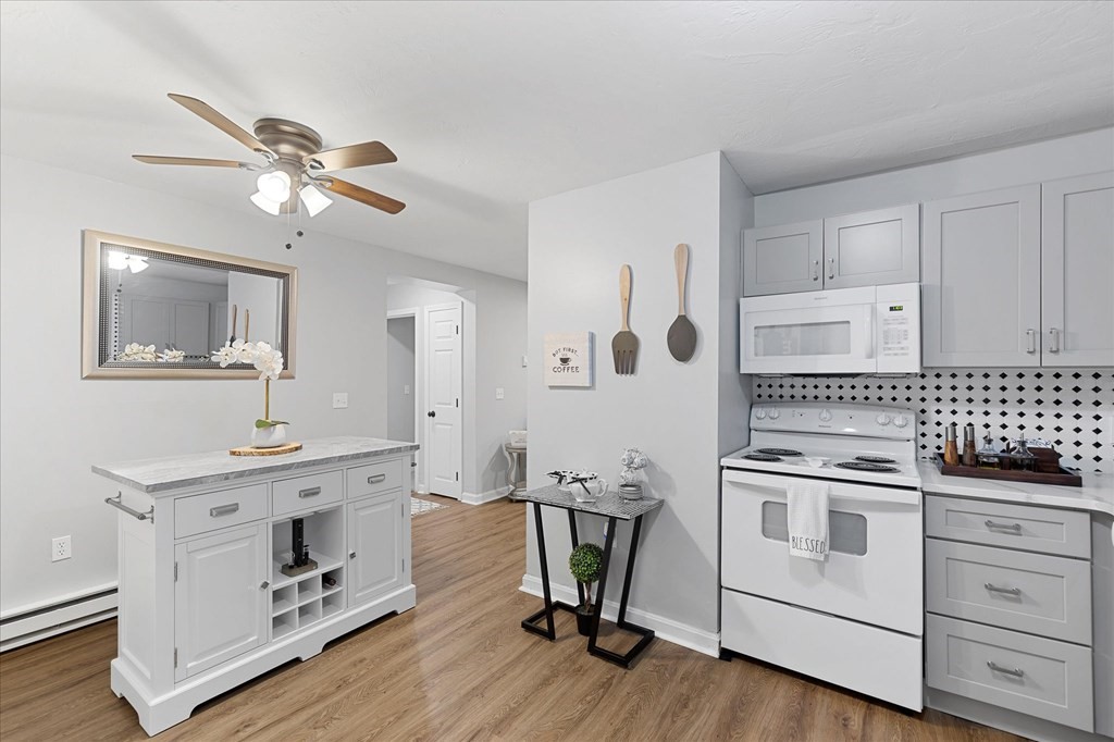 46 Gibbs Street, Unit 1D Worcester, MA 01607 - Photo 5 of 17 a kitchen with a stove a sink and a refrigerator