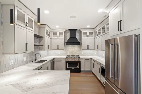 a kitchen with cabinets appliances and a sink