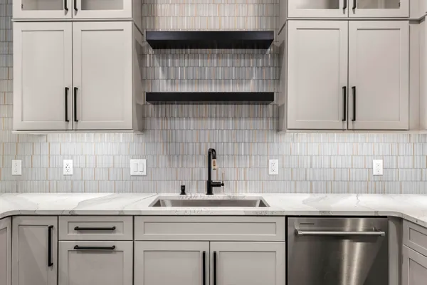 a kitchen with a sink cabinets and stainless steel appliances