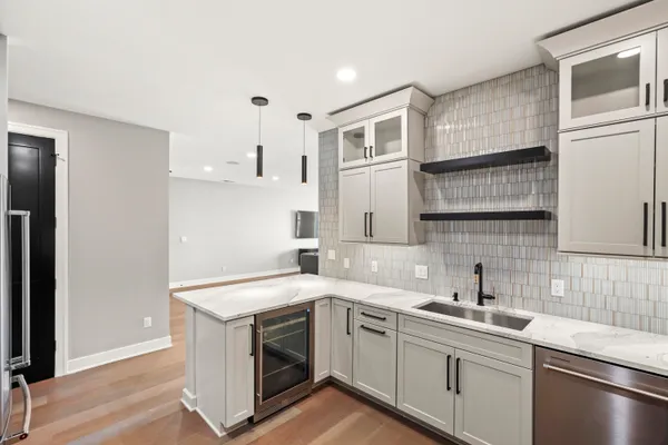 a kitchen with stainless steel appliances granite countertop a refrigerator and a sink