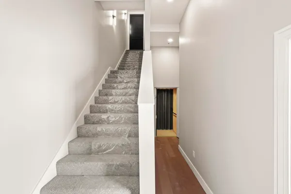 a view of a hallway with wooden floor