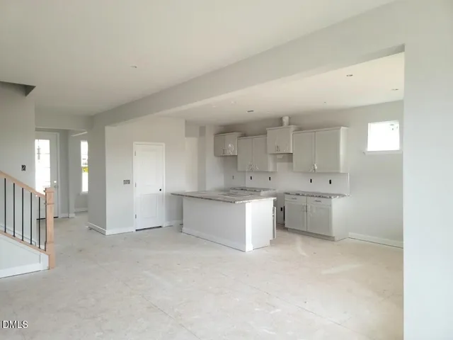 a large white kitchen with a sink
