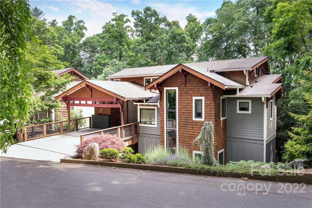 a front view of a house with a garden and plants