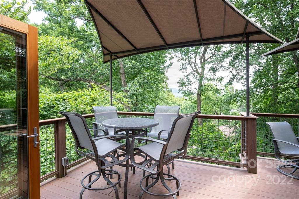 9 Kenilworth Road Asheville, NC 28803 - Photo 13 of 33 a view of a patio with table and chairs under an umbrella