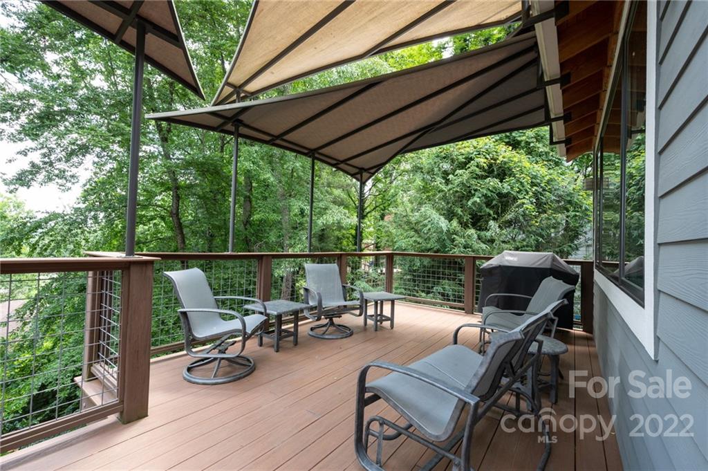 9 Kenilworth Road Asheville, NC 28803 - Photo 14 of 33 a view of a patio with chairs and wooden floor