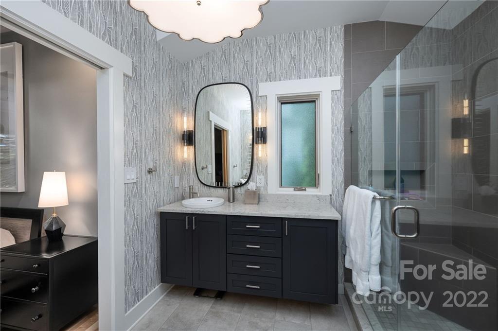 9 Kenilworth Road Asheville, NC 28803 - Photo 18 of 33 a spacious bathroom with a granite countertop sink a mirror and shower view